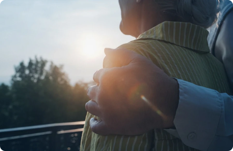 Hand on shoulder at sunset Website Image beside text 2000 x 1300 px