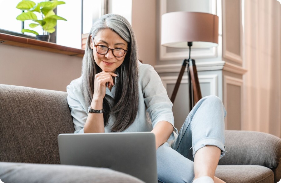 Woman on couch with laptop Website Image beside text 2000 x 1300 px
