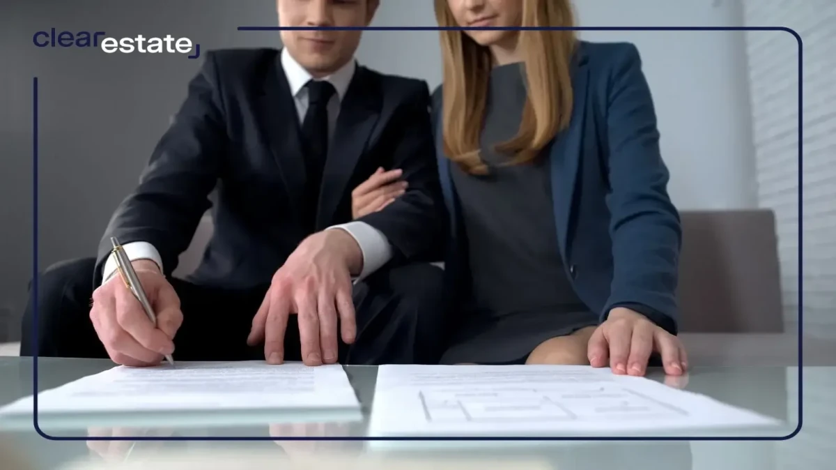Couple in suits signing a deal