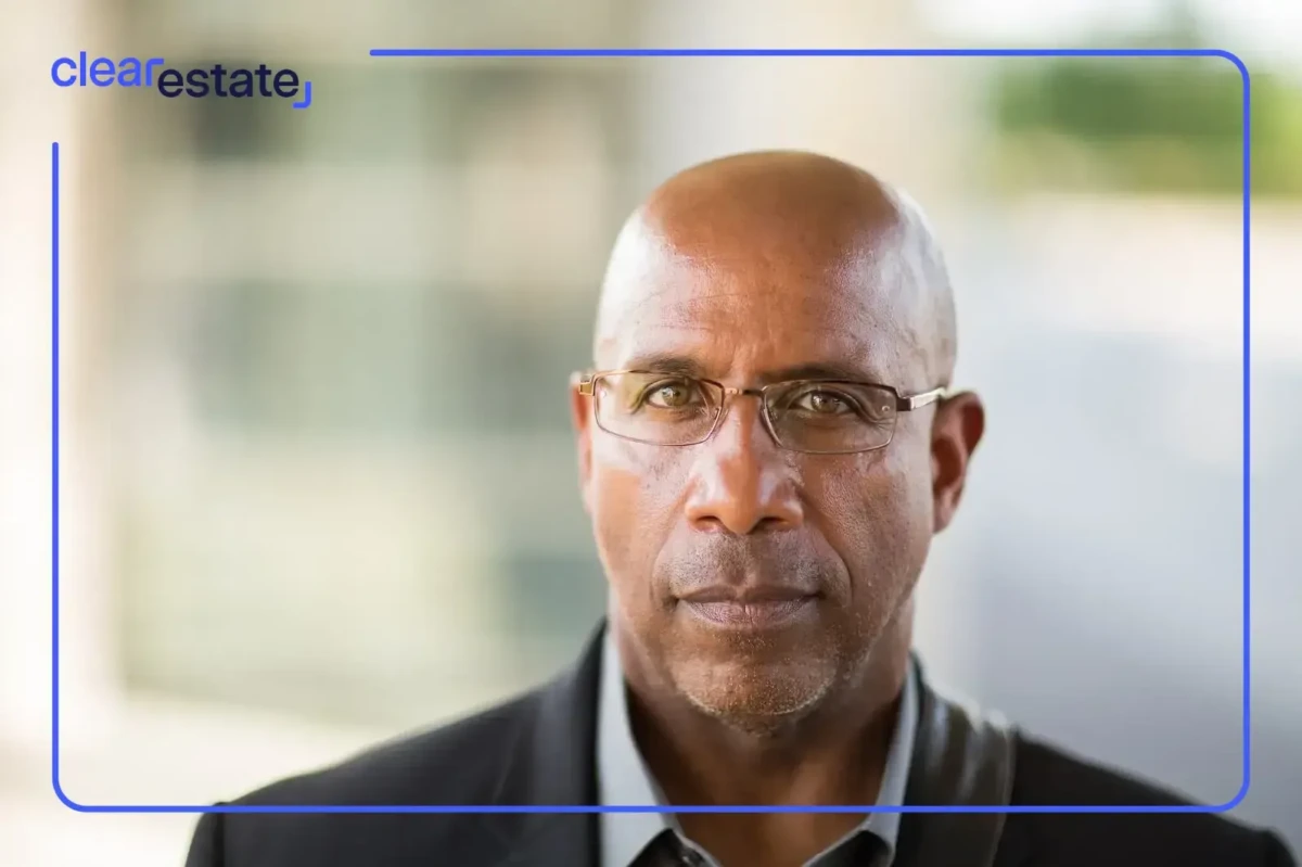 Serious man with glasses in black suit