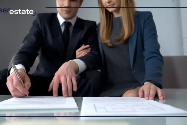 Couple in suits signing a deal