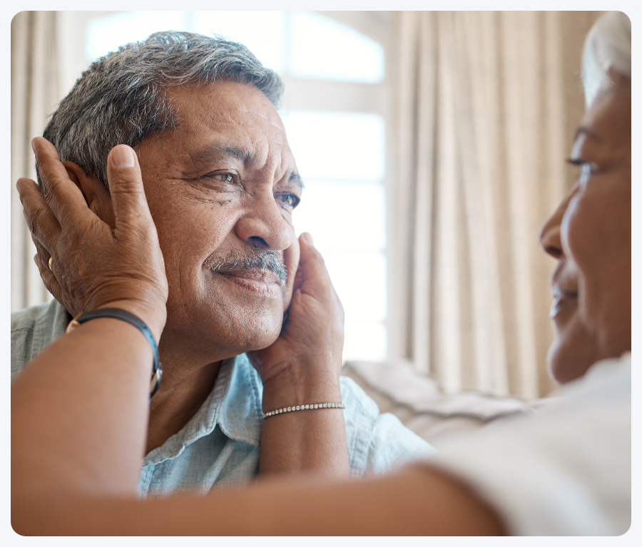 Man with womans hands on face